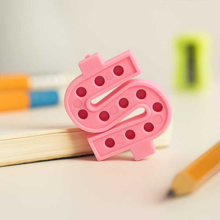 Pink textured object resembling a letter &