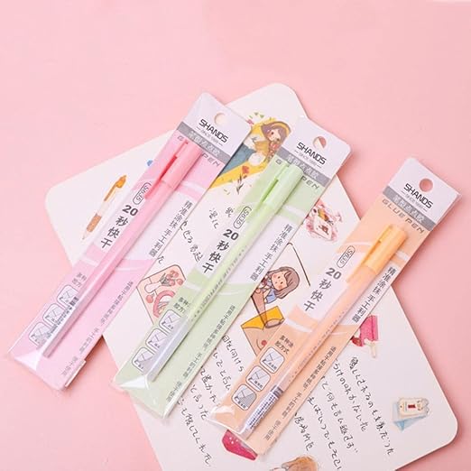 Set of stationery items including pens and notebooks on a pink background