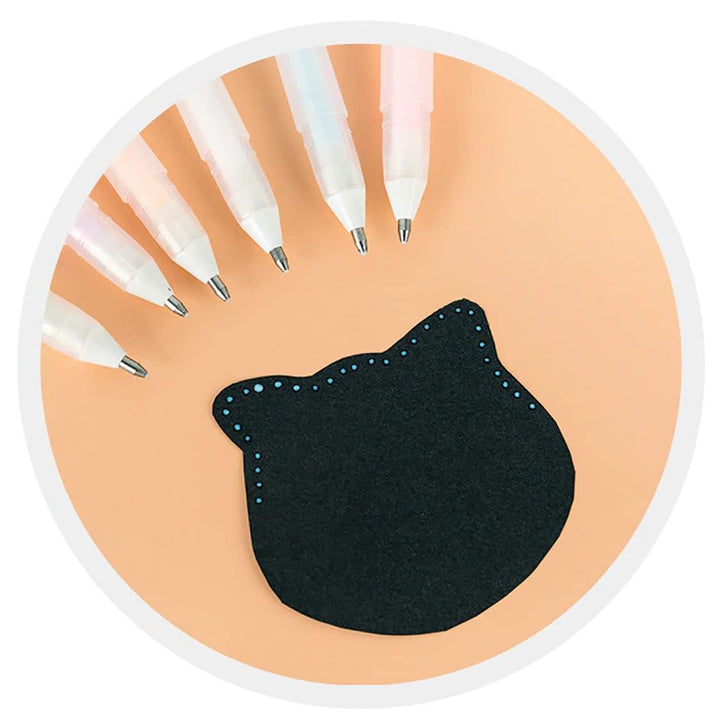 Black cat-shaped sticker on a peach-colored background with white pens.
