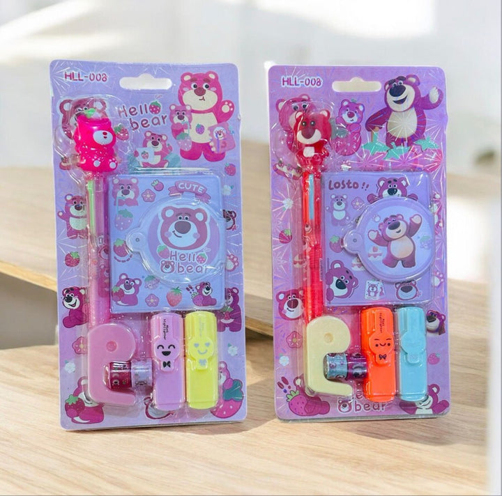 Two packages of cartoon bear-themed stationery items on a wooden surface.