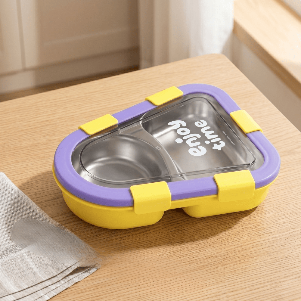 Kids 2 Compartment Lunch Box with Spoon &amp; ForkStainless Steel Lunch BoxCrafty CuddleYellow and purple food container on a wooden surfaceYellowKidsLunchBox BentoBox LunchBox SchoolLunch KidsEssentials LunchBoxIdeas BackToSchool LeakproofLunchBox KidsLunch TiffinBox