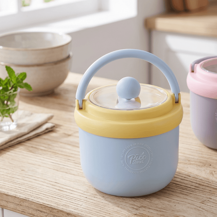 Kids Insulated Soup Lunch Box with HandleStainless Steel Lunch BoxCrafty CuddlePastel - colored container with a handle on a wooden surface, with &