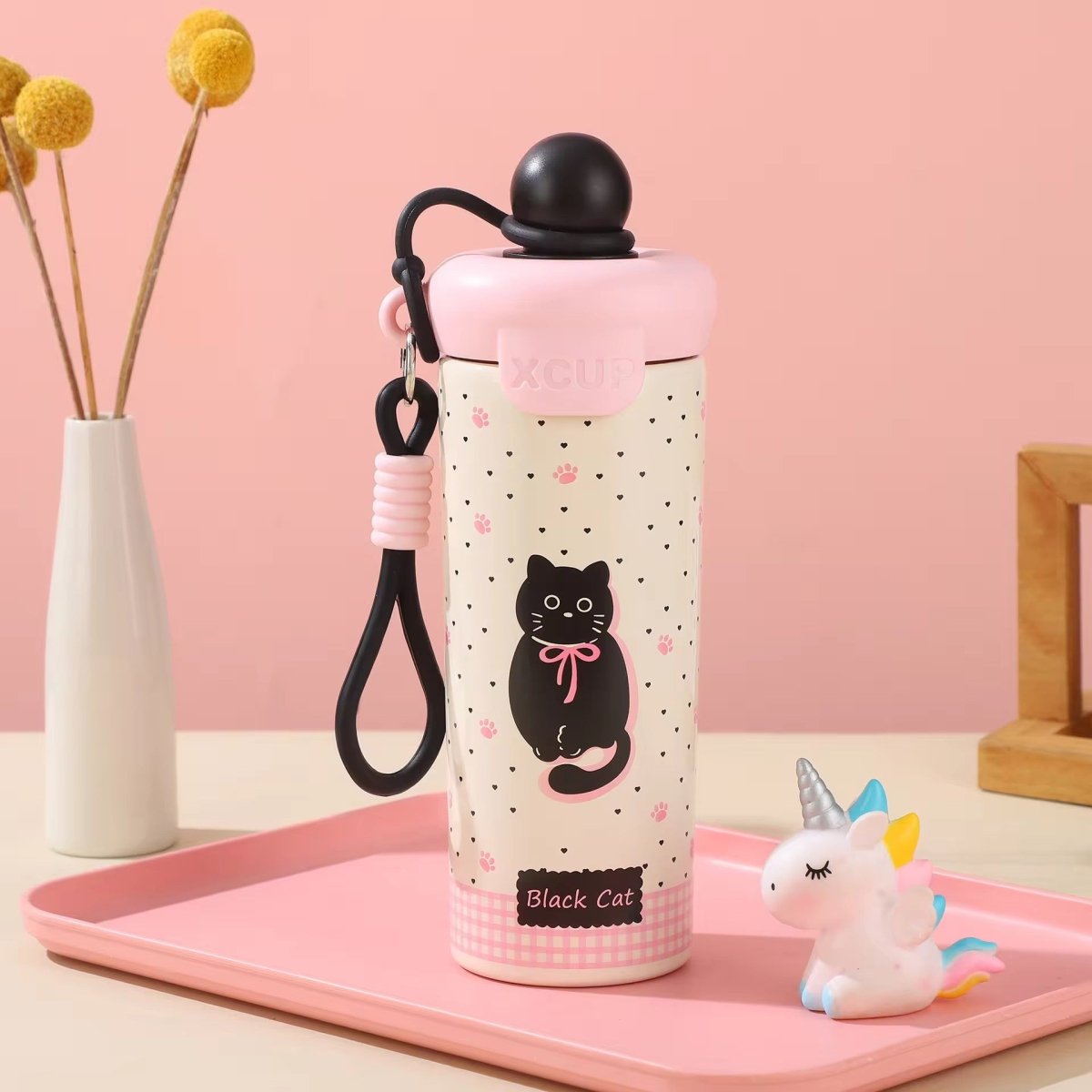 Kids Insulated Water BottleCartoon Kids Water BottleCrafty CuddleA cute stainless steel water bottle with a pink lid and a black cat illustration, displayed on a pink tray next to a small unicorn figurine.BlackStainlessSteelBottle InsulatedBottle WaterBottle KidsWaterBottle LeakproofBottle ReusableBottle SchoolEssentials TravelBottle HydrationOnTheGo CuteWaterBottle