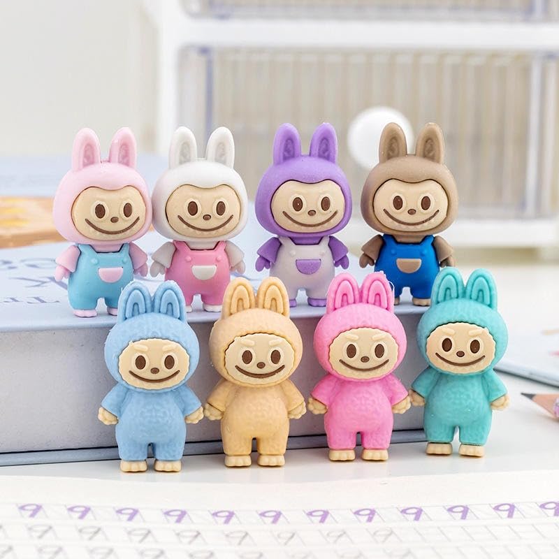 Set of colorful cartoon character figurines on a white surface with a blurred background.
