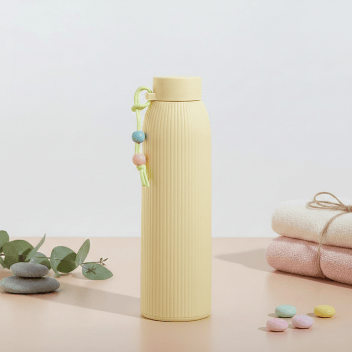 Leak Proof Mini Glass BottleCartoon Kids Water BottleCRAFTY CUDDLEBeige ribbed water bottle with decorative elements on a light backgroundYellow330mlBottle GlassWaterBottle MiniWaterBottle LeakProofBottle SiliconeSleeveBottle TravelWaterBottle OfficeWaterBottle ReusableBottle PastelBottle EcoFriendlyBottle
