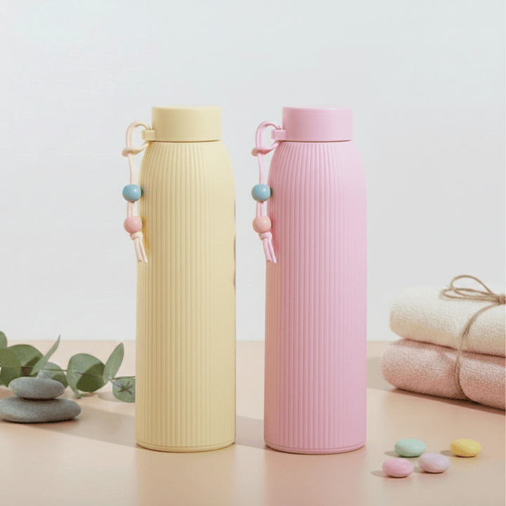 Leak Proof Mini Glass BottleCartoon Kids Water BottleCRAFTY CUDDLETwo pastel - colored water bottles on a light background with decorative elements.Yellow330mlBottle GlassWaterBottle MiniWaterBottle LeakProofBottle SiliconeSleeveBottle TravelWaterBottle OfficeWaterBottle ReusableBottle PastelBottle EcoFriendlyBottle