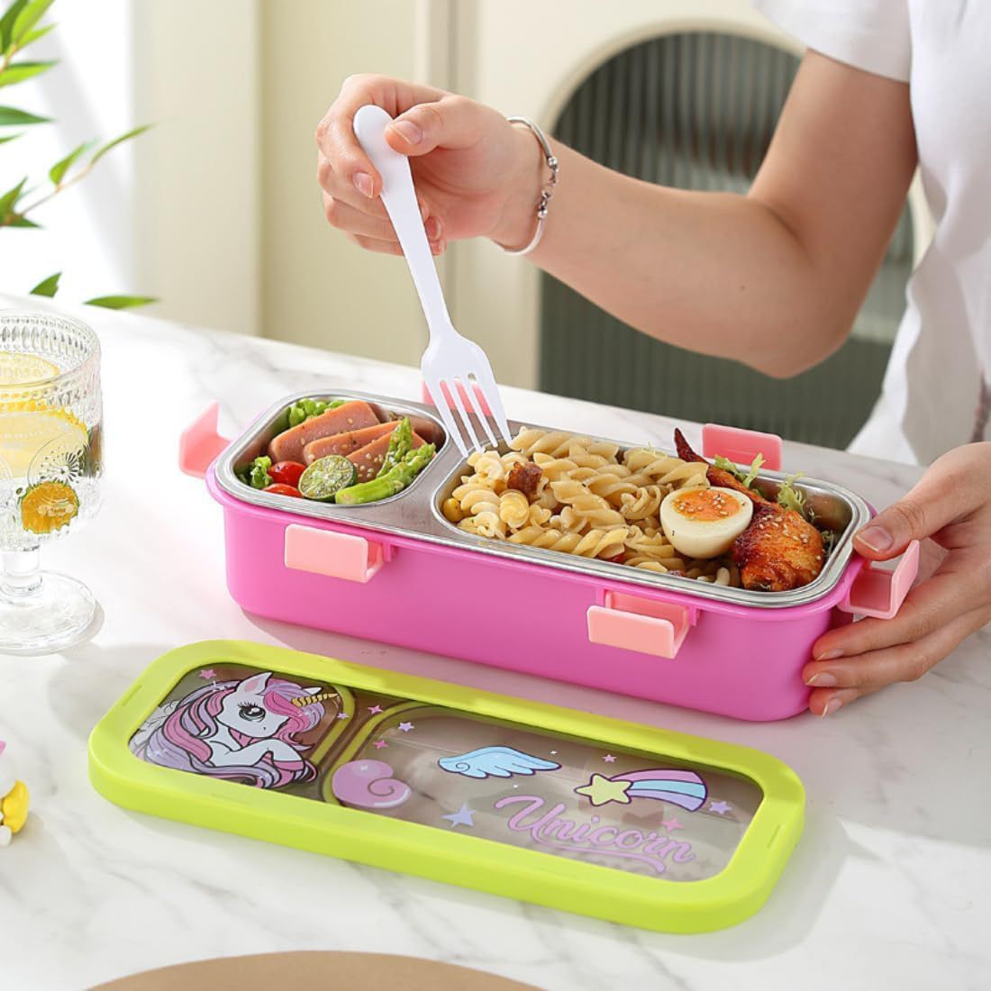 Leakproof Bento Box with Spoon ForkStainless Steel Lunch BoxCrafty CuddlePerson opening a pink bento box with compartments filled with food on a white table.Dinosaur