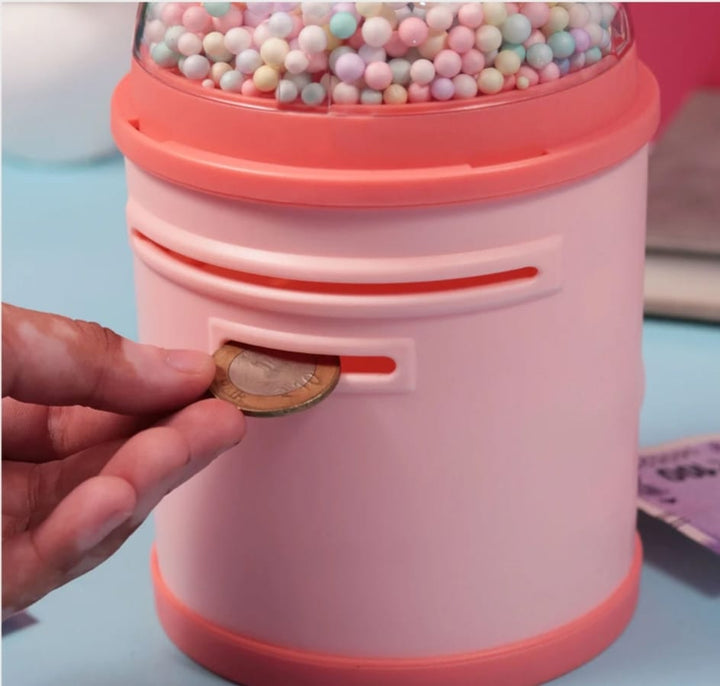 Close-up of Hand Inserting Money into Peach Unicorn Piggy Bank with Locker – Fun Way for Kids to Save