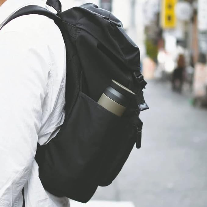 Person placing 350ml olive green insulated water bottle into a bag, compact and travel-friendly stainless steel vacuum flask