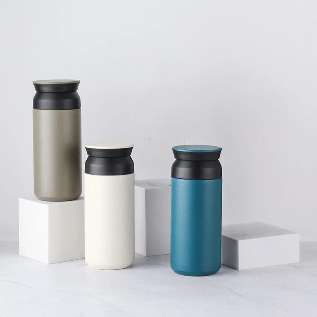 Set of 350ml mini insulated vacuum cups in olive green, cream white, and teal blue with black lids, stainless steel bottles .