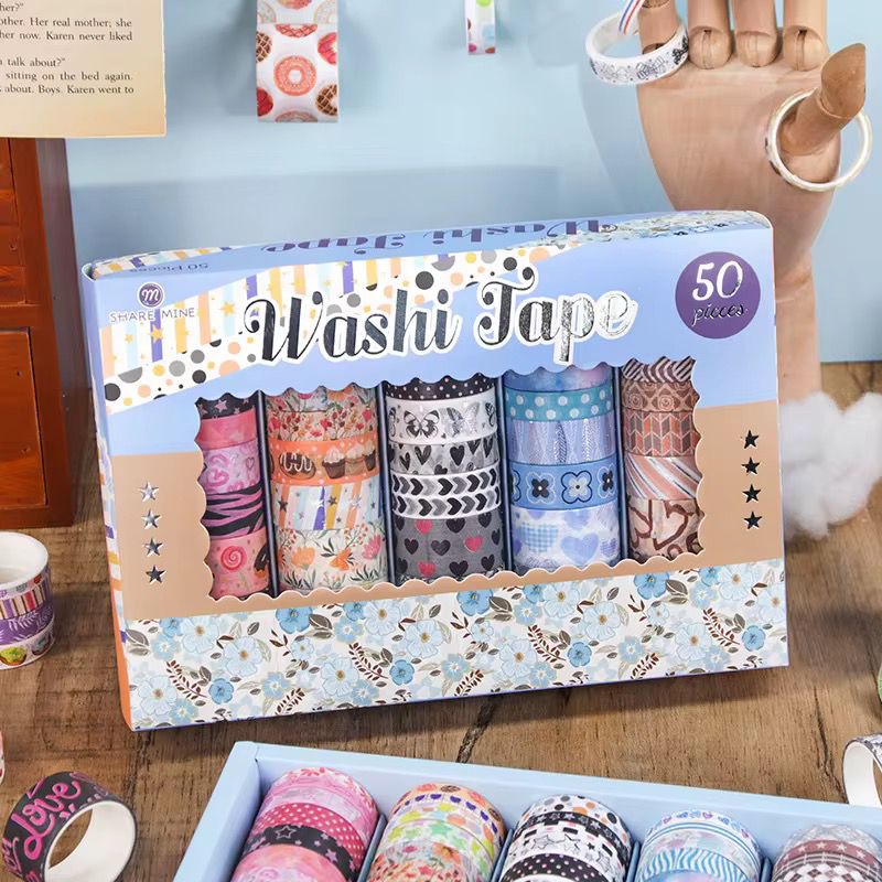 Multi - Design Washi Tape Set – 50 RollsDecorative Washi TapeCRAFTY CUDDLEBox of washi tape with colorful designs on a wooden surface