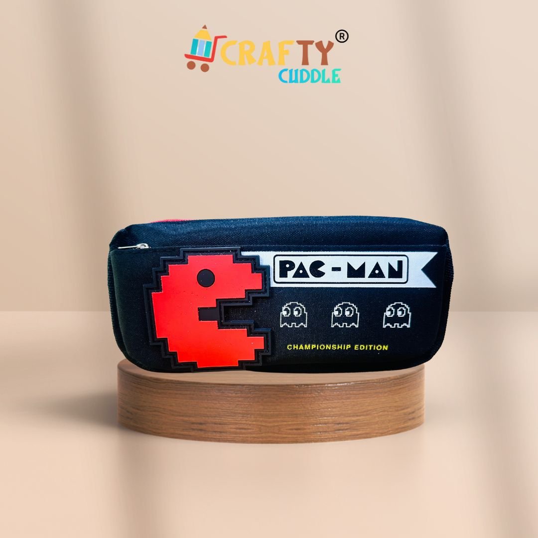 Pac-Man themed black pencil pouch for kids featuring a red pixelated Pac-Man design and ghost icons, labeled "Championship Edition", displayed on a wooden platform with a peach background. Crafty Cuddle logo on top.