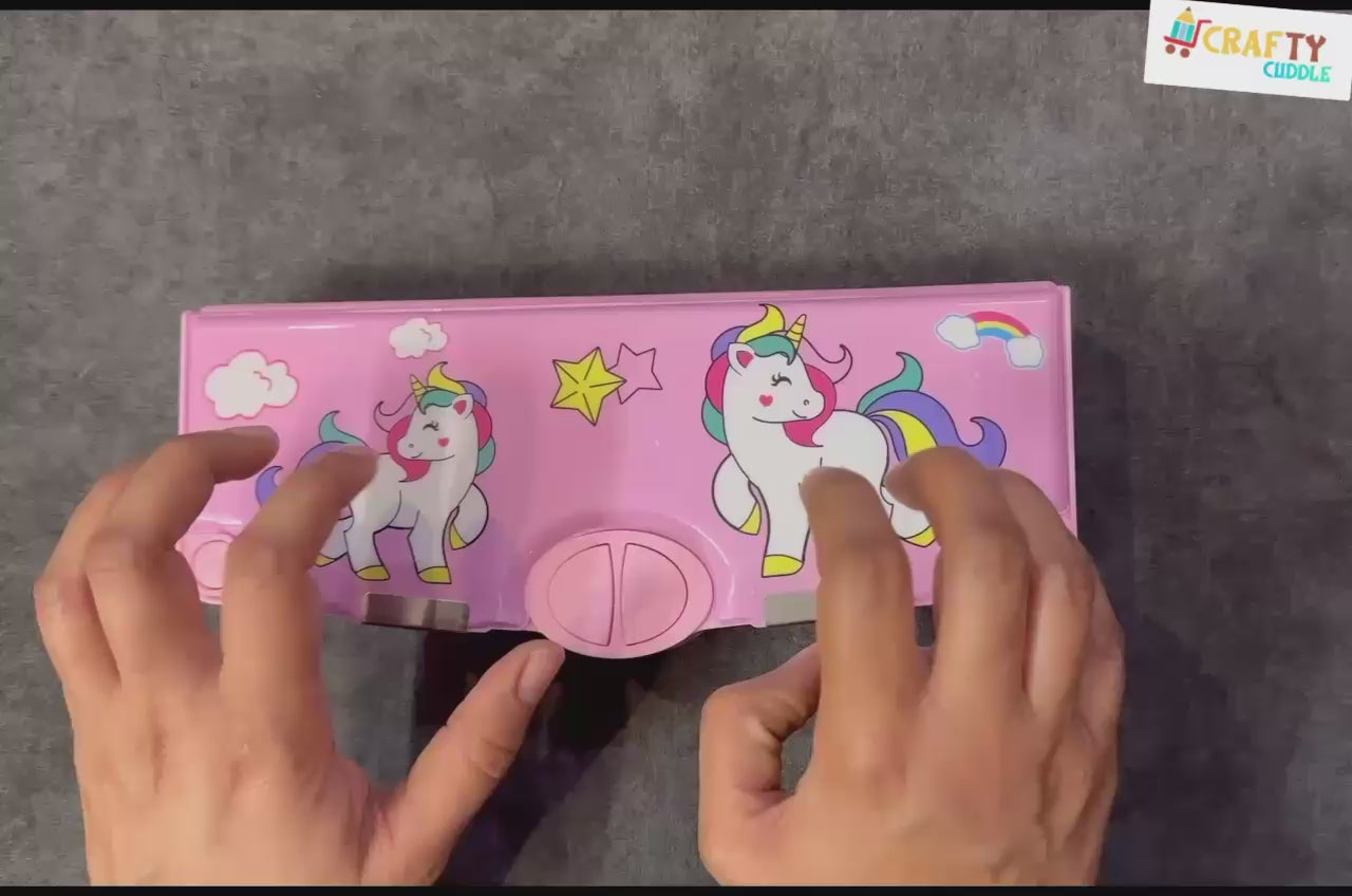 Pink multi-compartment pencil box with a unicorn pattern, ideal for organizing stationery.