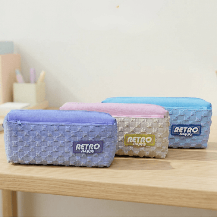 Retro Happy Pencil PouchRetro Pencil PouchCrafty CuddleThree retro - style pencil cases on a wooden surface with a light backgroundBlueback to school pouchCrafty Cuddle pouch