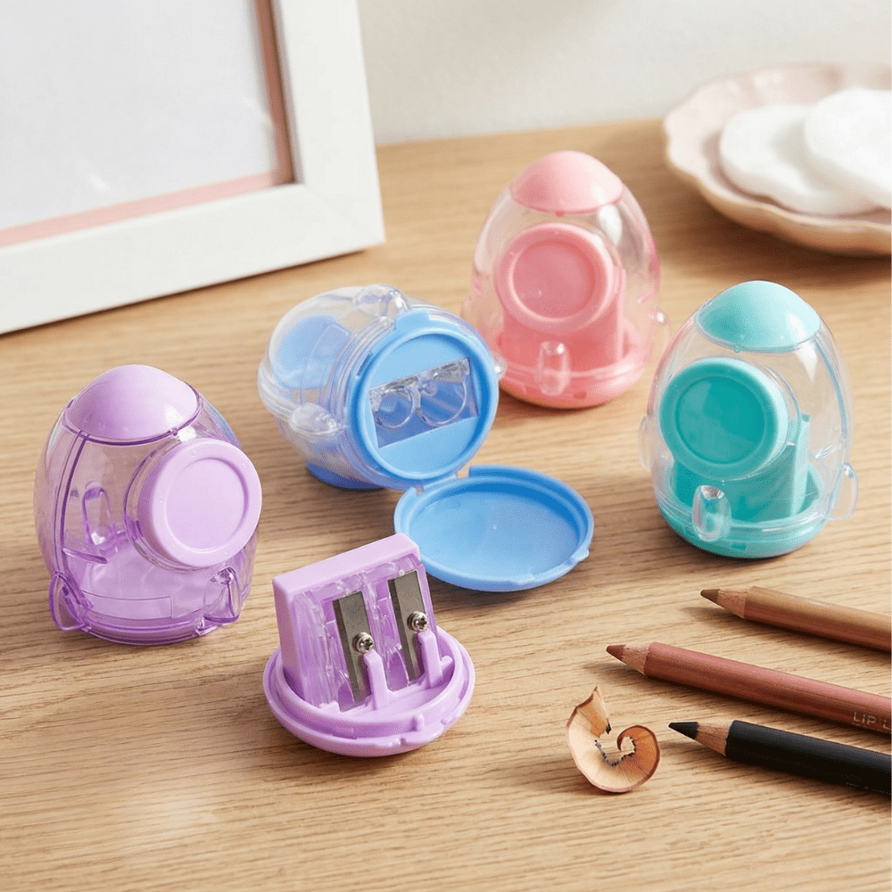 Rocket Blast Pencil SharpenerCrafty CuddleSet of colorful pencil sharpeners on a wooden surface with pencils and a sharpener.1