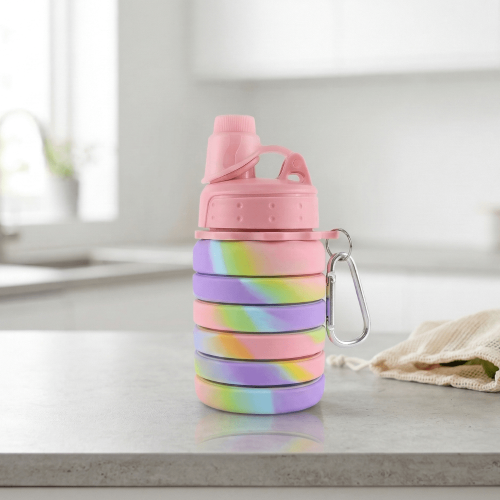 Silicone Collapsible Sipper BottleSilicone Water BottleCrafty CuddleCollapsible water bottle with tie - dye design on a light surfaceSilicone Bottle PinkPinkBPA free bottlecollapsible water bottle