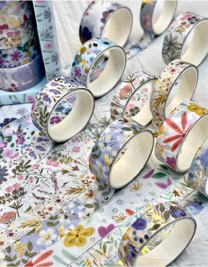 Sky Blue Floral Washi Tape SetCRAFTY CUDDLEAssorted rolls of floral - patterned tape on a textured surface
