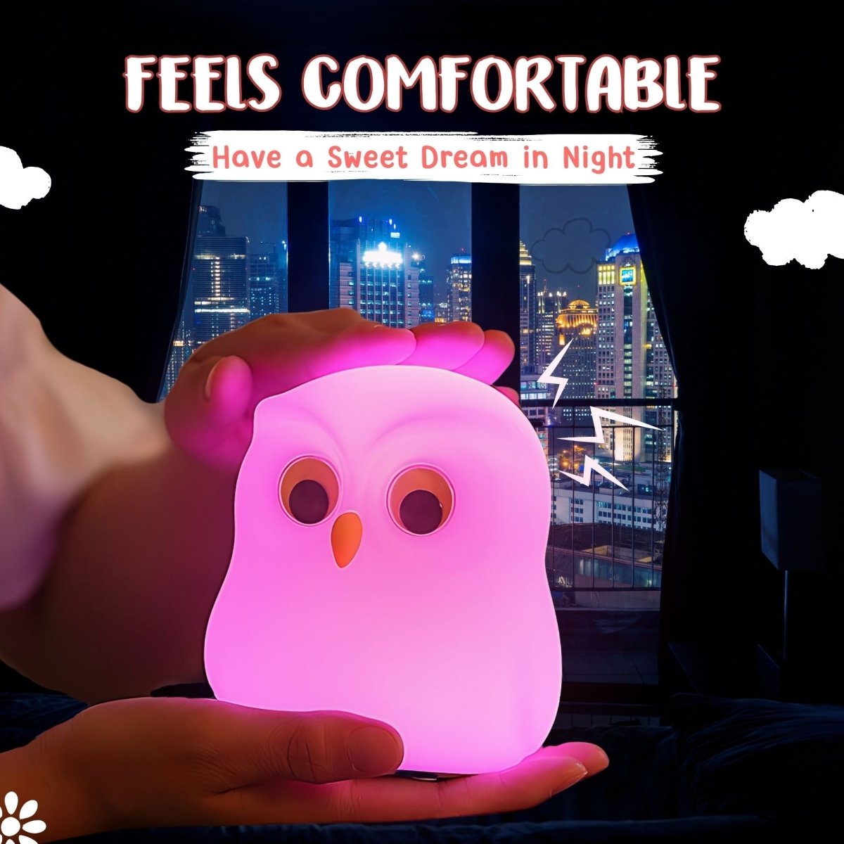 Person holding a glowing owl-shaped night light with cityscape in the background