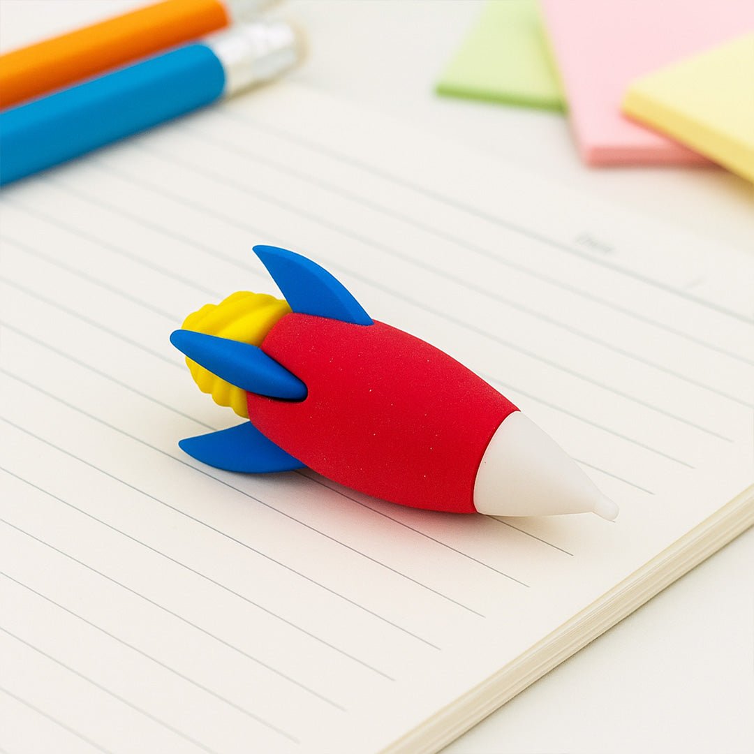 Colorful rocket-shaped eraser on a notebook with pens and sticky notes in the background