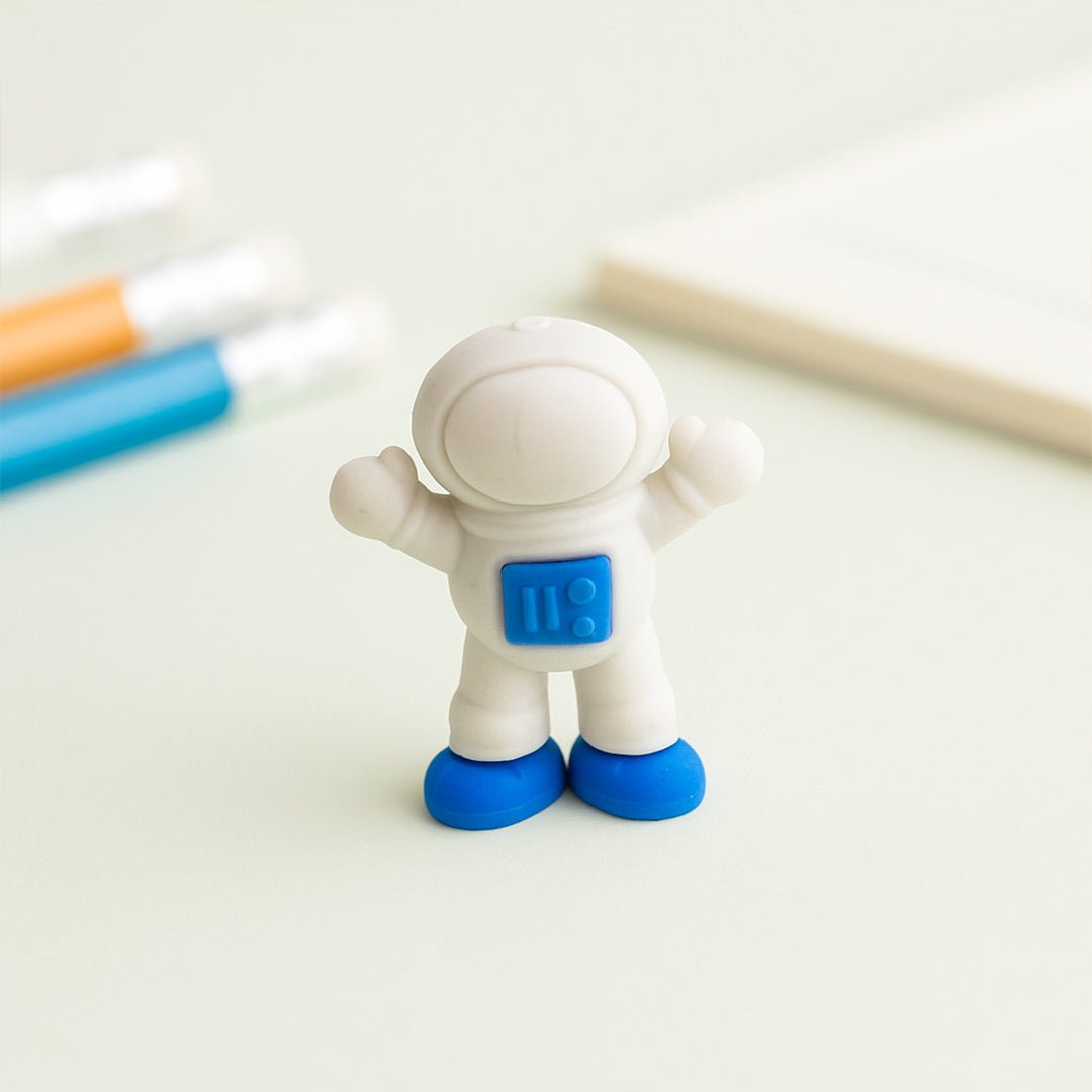 Spaceman eraser with blue feet on a white background