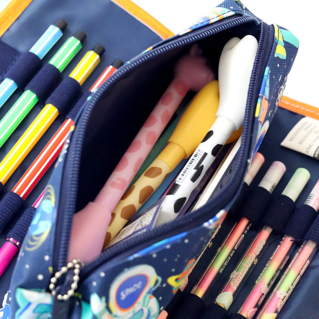 Open space-themed pencil pouch for kids showing pens and pencils inside