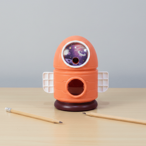 Space - Themed Pencil SharpenerStationery > Erasers &amp; SharpenersCRAFTY CUDDLEOrange rocket - shaped pencil sharpener with a galaxy design on a gray backgroundOrangeKidsStationery SpaceTheme CuteStationery SchoolSupplies KawaiiStationery BackToSchool StationeryAddict StudyEssentials ReturnGiftIdeas StationeryLove