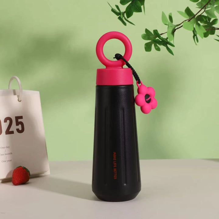 Stainless Steel Water Bottle with HandleCartoon Kids Water BottleCrafty CuddleBlack water bottle with pink cap and handle on a light surface with a green backgroundBlack