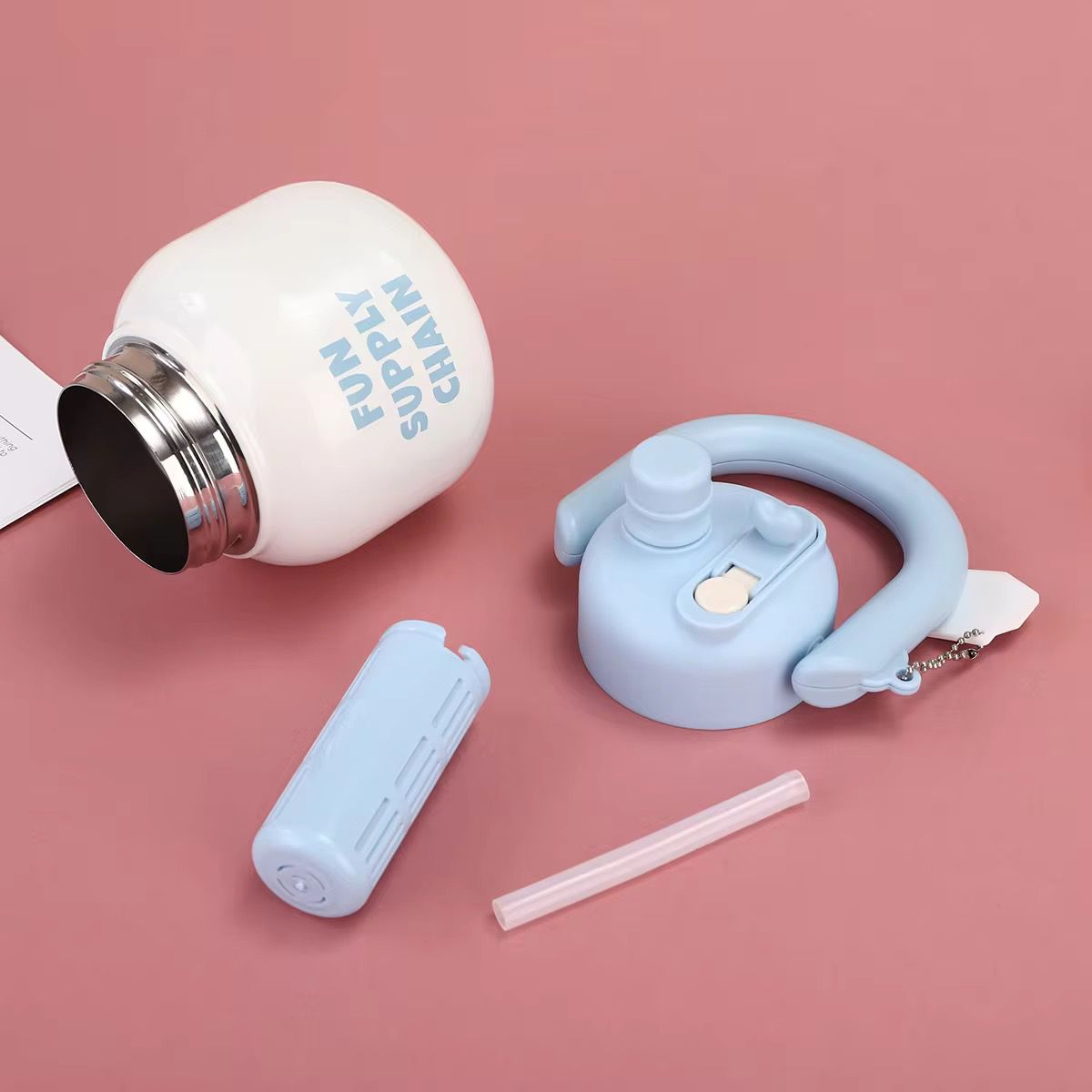 Stainless Steel Wide Mouth Water BottleTumblersCRAFTY CUDDLEWhite water bottle with blue cap, straw, and carrying strap on a pink backgroundSky BlueStainlessSteelBottle WideMouthBottle InfuserBottle ReusableStraw TravelWaterBottle GymWaterBottle LeakproofBottle DetoxWaterBottle PortableBottle EcoFriendlyLifestyle