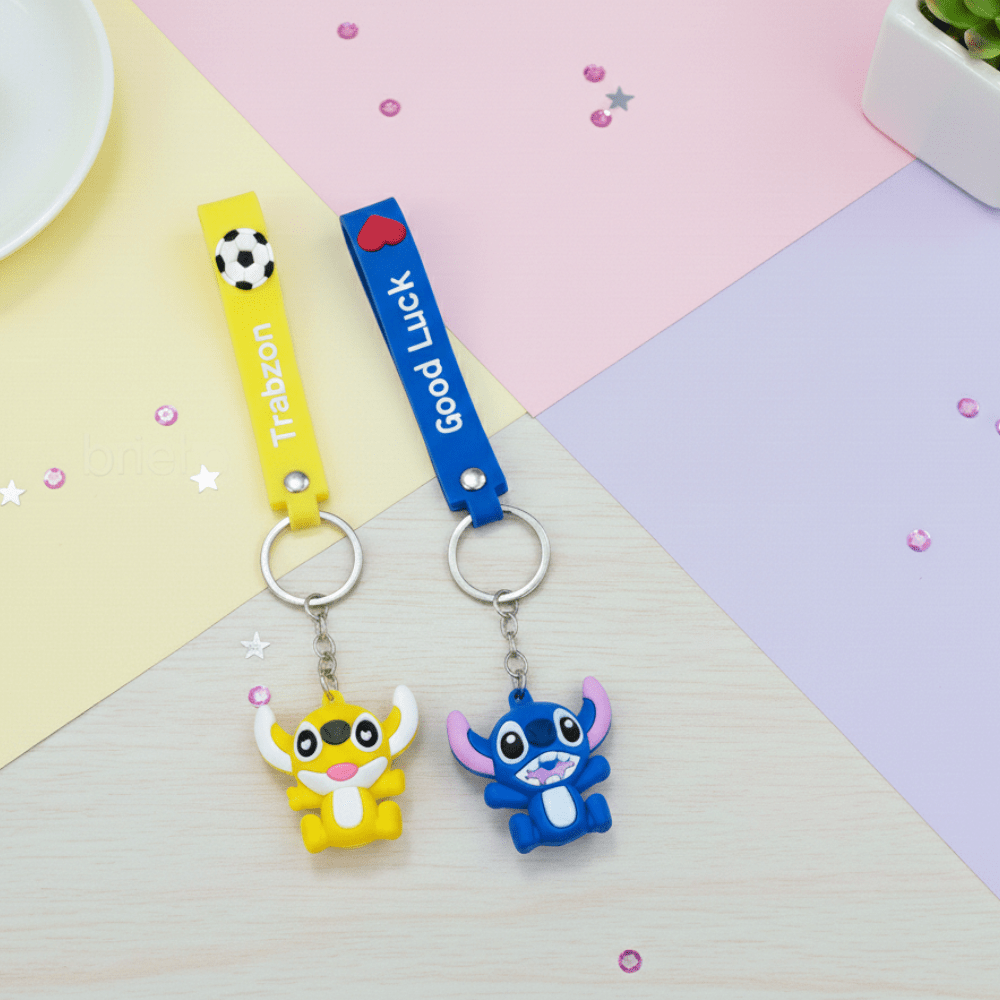 Stitch Theme Keychain with StrapKeychainsCRAFTY CUDDLETwo cartoon character keychains on a colorful geometric background1CartoonKeychain CuteKeyring MonsterKeychain KawaiiAccessories KidsBagCharm BackpackAccessory ReturnGifts TrendyKeychains SiliconeKeyring GiftForKids