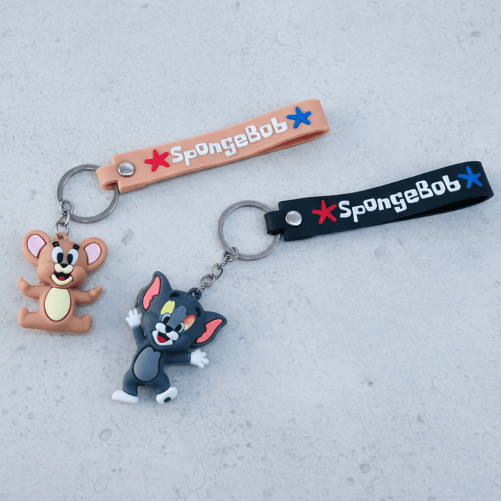 Tom &amp; Jerry Cartoon Silicone KeychainKeychainsCRAFTY CUDDLETwo keychains featuring cartoon characters on a gray surface with &