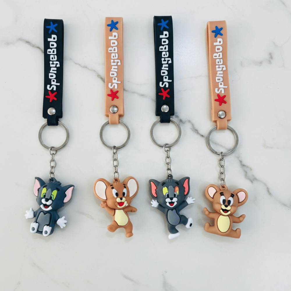 Tom &amp; Jerry Cartoon Silicone KeychainKeychainsCRAFTY CUDDLEFour keychains featuring cartoon characters on a marble surface2 (1 Tom &amp; 1 Jerry)TomAndJerry CartoonKeychain CuteKeychain KeyringLove BagCharms AnimeAccessories KidsAccessories ReturnGiftIdeas TrendyKeychains GiftForKids