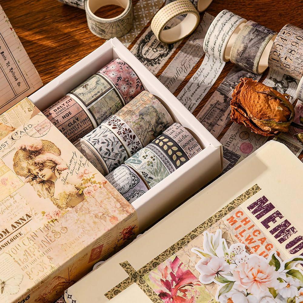 Washi Tape Box of 20 – Letters from Anna SeriesCRAFTY CUDDLECollection of decorative washi tape rolls in a box on a wooden surface.