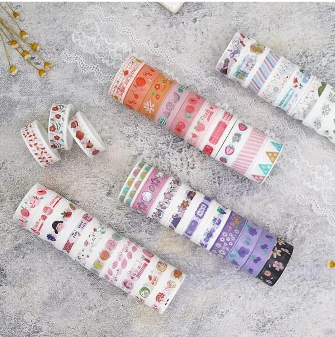 Set of colorful washi tape rolls on a textured surface