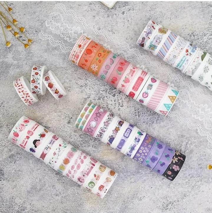 Set of colorful washi tape rolls on a textured surface